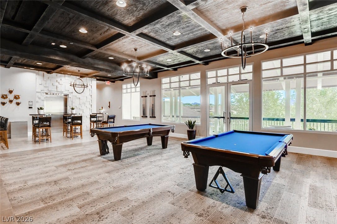 647 Longfeather Street, Henderson, NV 89011 Dramatic coffered wood ceilings and walls of windows define this spacious recreation room.