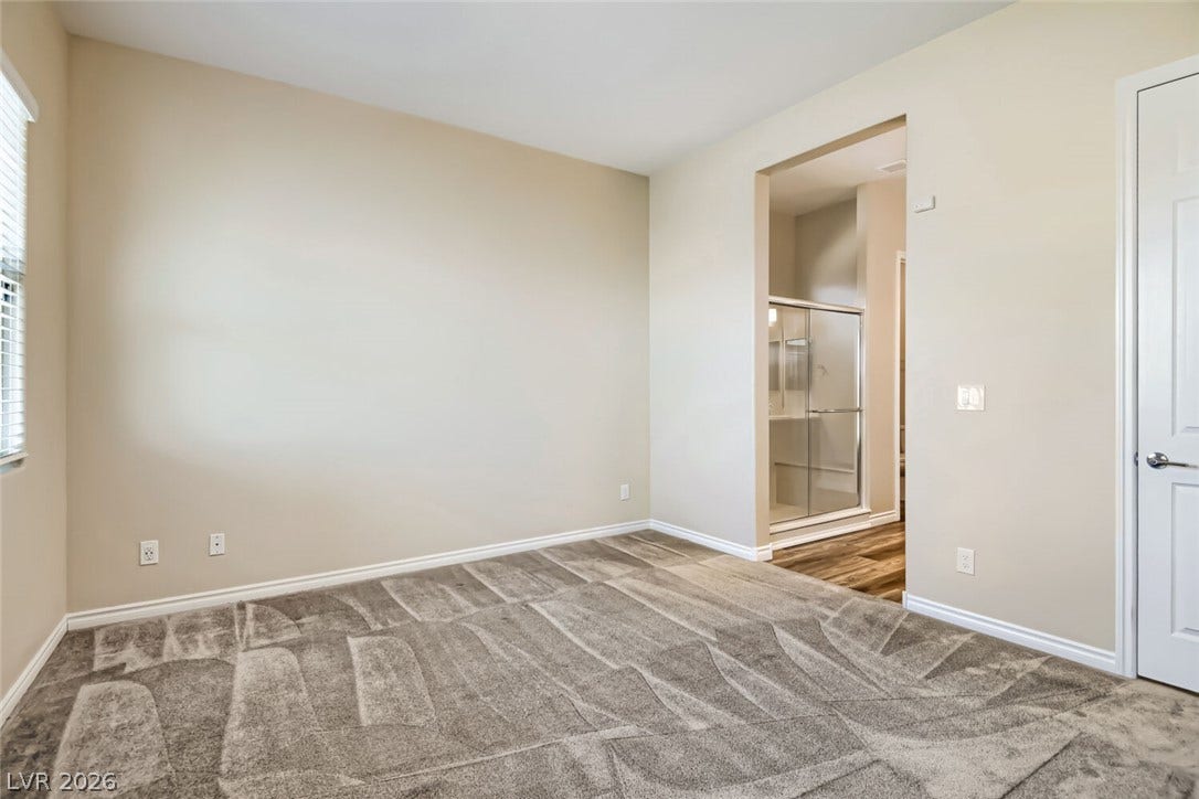 647 Longfeather Street, Henderson, NV 89011 Soft carpeting underfoot defines this comfortable bedroom complete with an attached private bath.