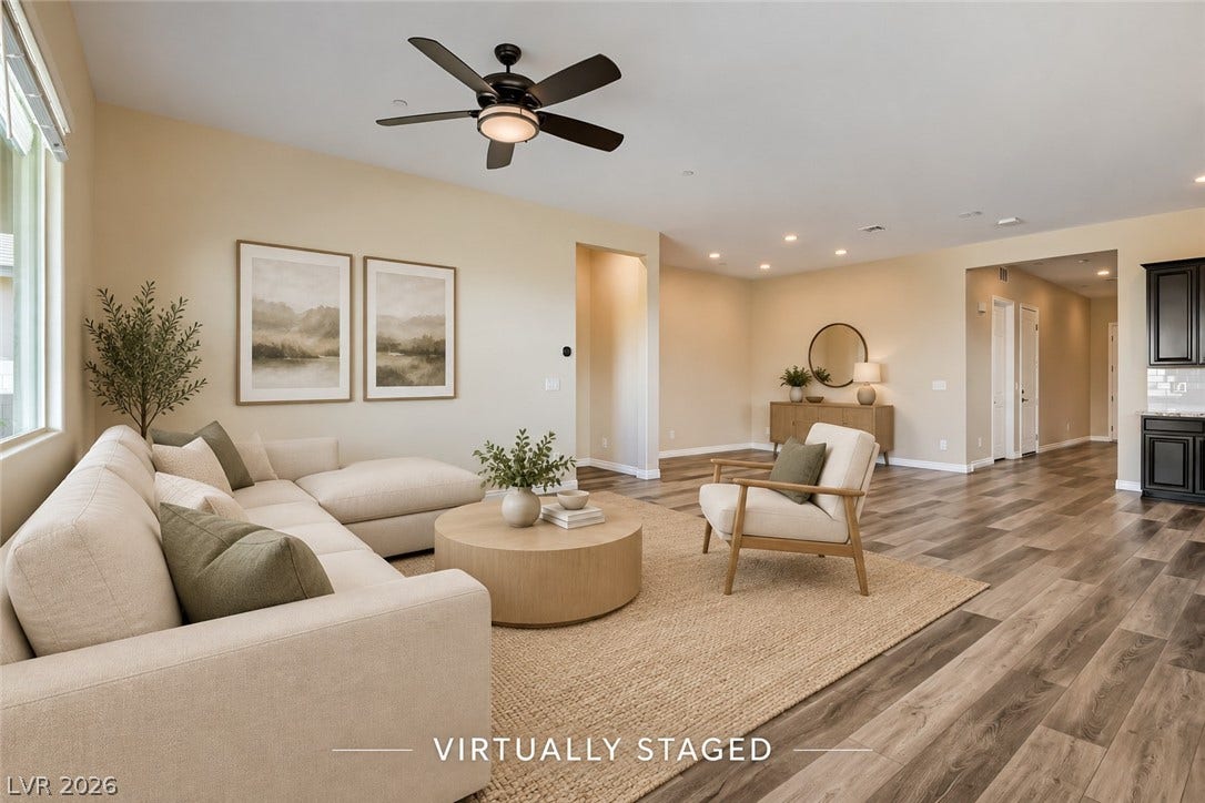 647 Longfeather Street, Henderson, NV 89011 Warm wood-look flooring and an open layout define this inviting main living area.