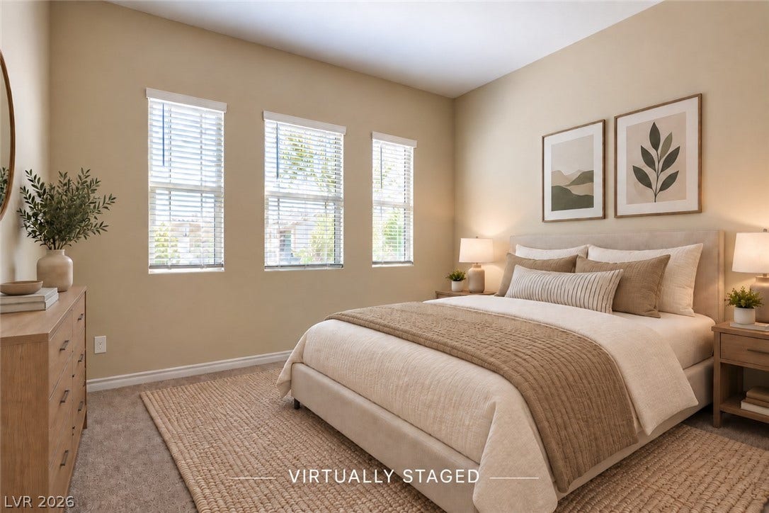 647 Longfeather Street, Henderson, NV 89011 Natural light streams through three tall windows into this comfortable carpeted bedroom.