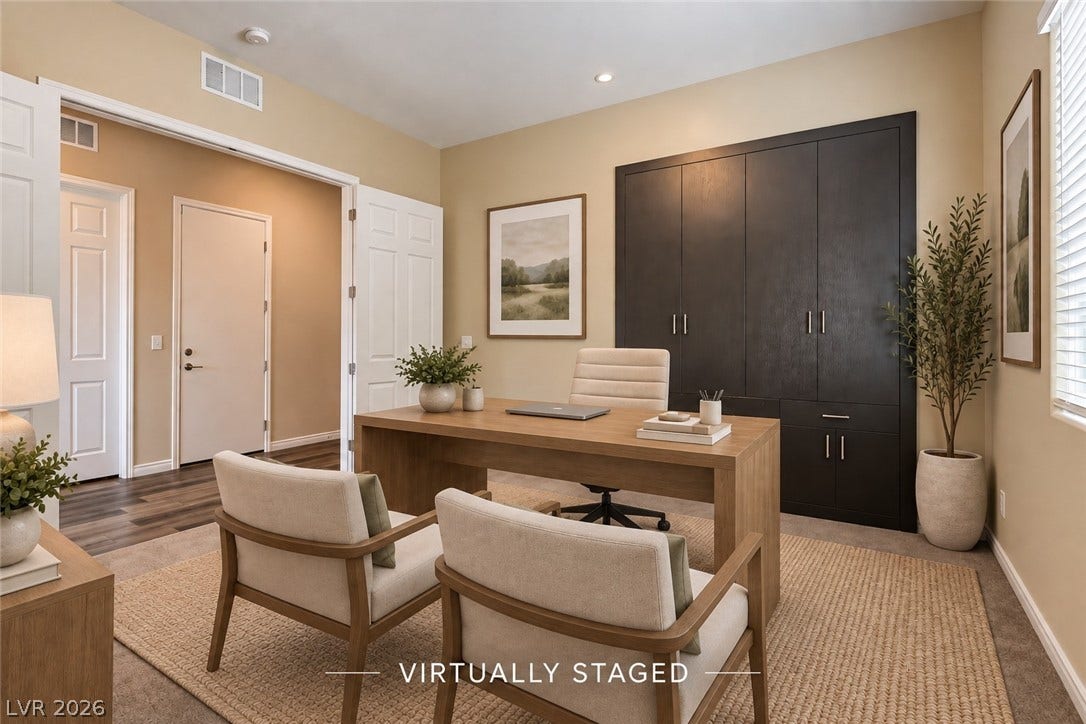 647 Longfeather Street, Henderson, NV 89011 Custom built-in cabinetry and warm wood flooring define this versatile home workspace.