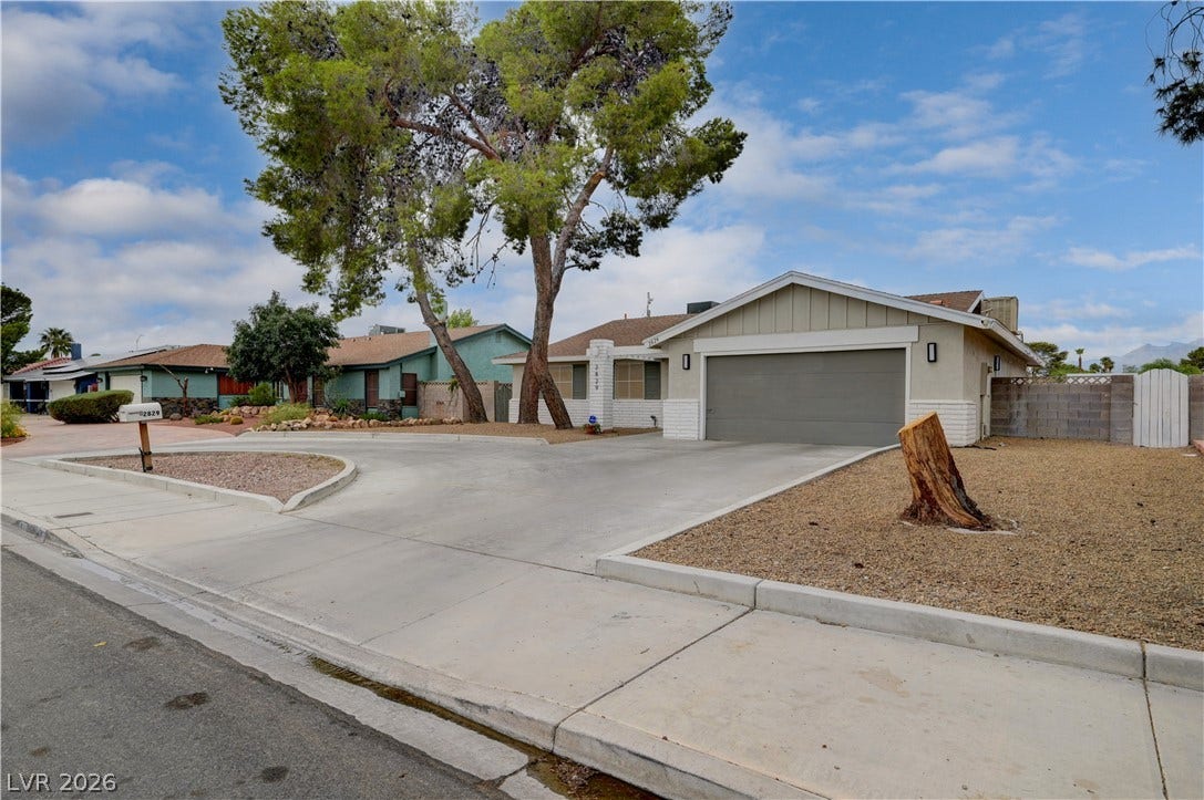 2829 N Michael Way, Las Vegas, NV 89108 Mature trees shade the front yard and expansive concrete driveway of this low-maintenance ranch-style home.