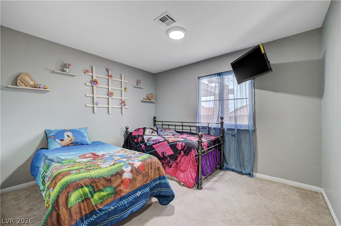 2829 N Michael Way, Las Vegas, NV 89108 Soft carpeted flooring and neutral walls define this comfortable secondary bedroom.