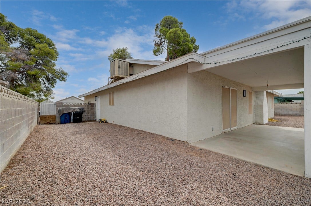 2829 N Michael Way, Las Vegas, NV 89108 An inviting covered patio borders a low-maintenance gravel yard with classic stucco walls.