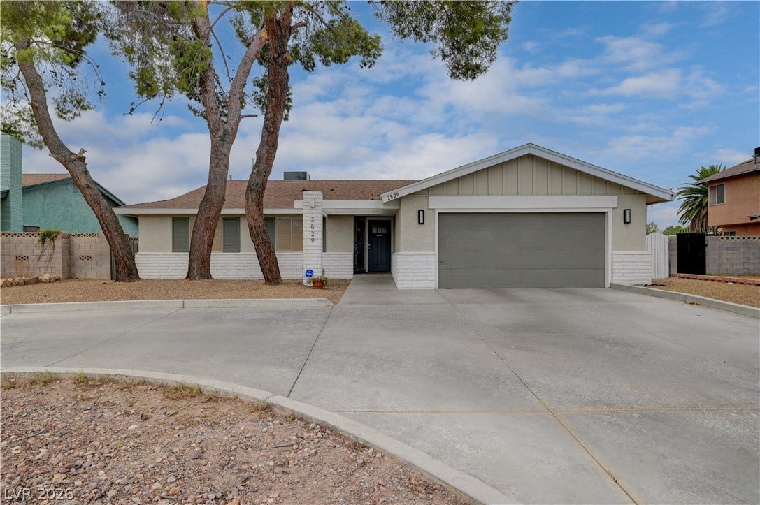 2829 N Michael Way, Las Vegas, NV 89108 Mature trees frame the classic facade of this inviting single-story home featuring a spacious driveway.