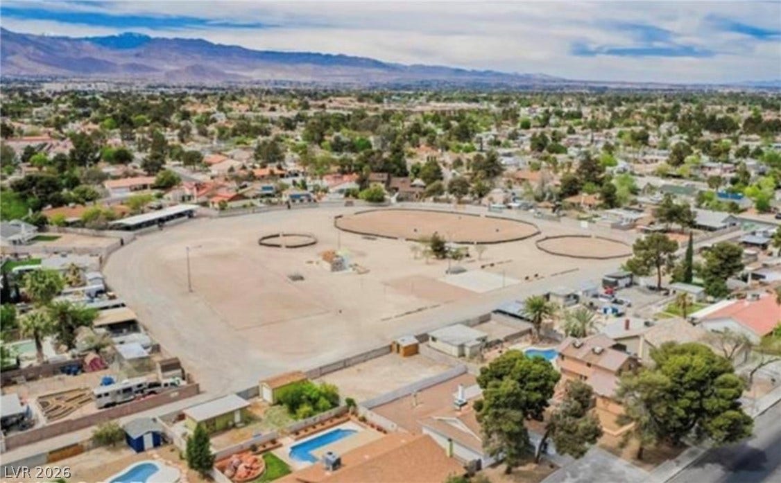 2829 N Michael Way, Las Vegas, NV 89108 A spacious equestrian arena anchors this aerial view of the neighborhood landscape.