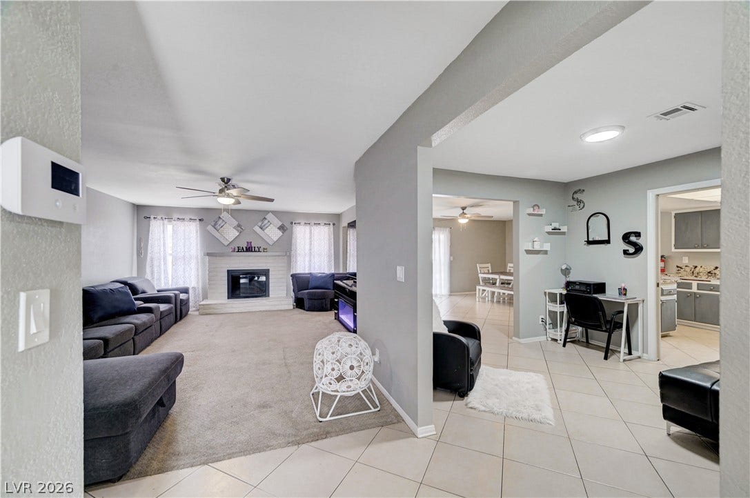 2829 N Michael Way, Las Vegas, NV 89108 An open floorplan seamlessly connects the carpeted living area to tiled transition spaces.