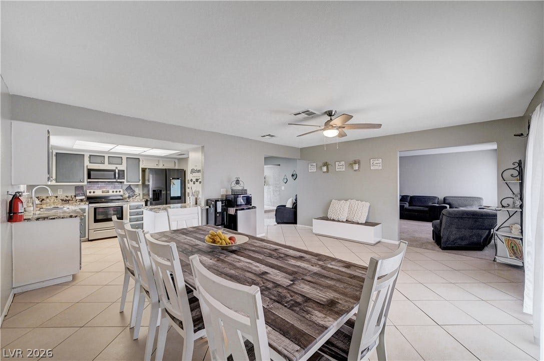 2829 N Michael Way, Las Vegas, NV 89108 An open floorplan seamlessly connects the tiled dining space to the adjacent kitchen and living areas.