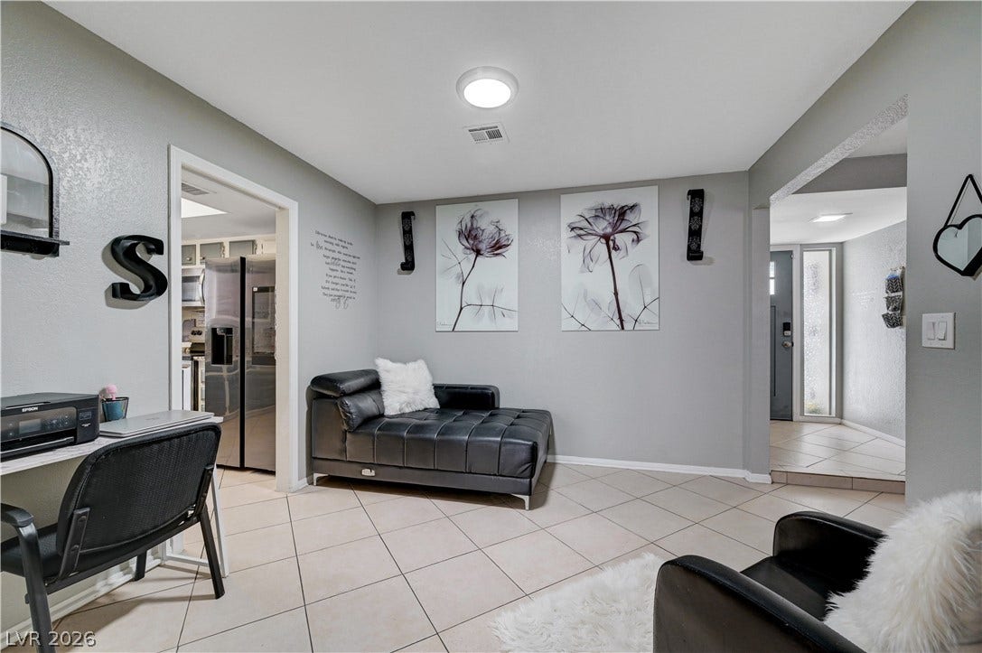 2829 N Michael Way, Las Vegas, NV 89108 Tiled flooring and broad arched transitions flow smoothly into the adjacent kitchen and entryway.