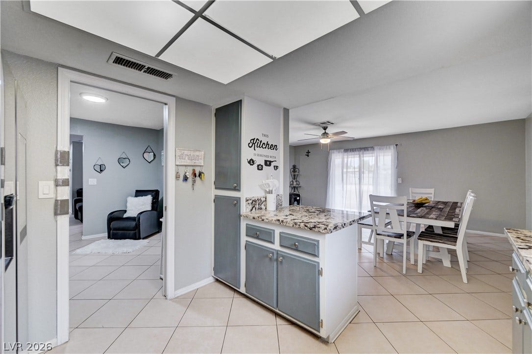 2829 N Michael Way, Las Vegas, NV 89108 Gleaming tile floors flow from the kitchen into the adjoining dining area.