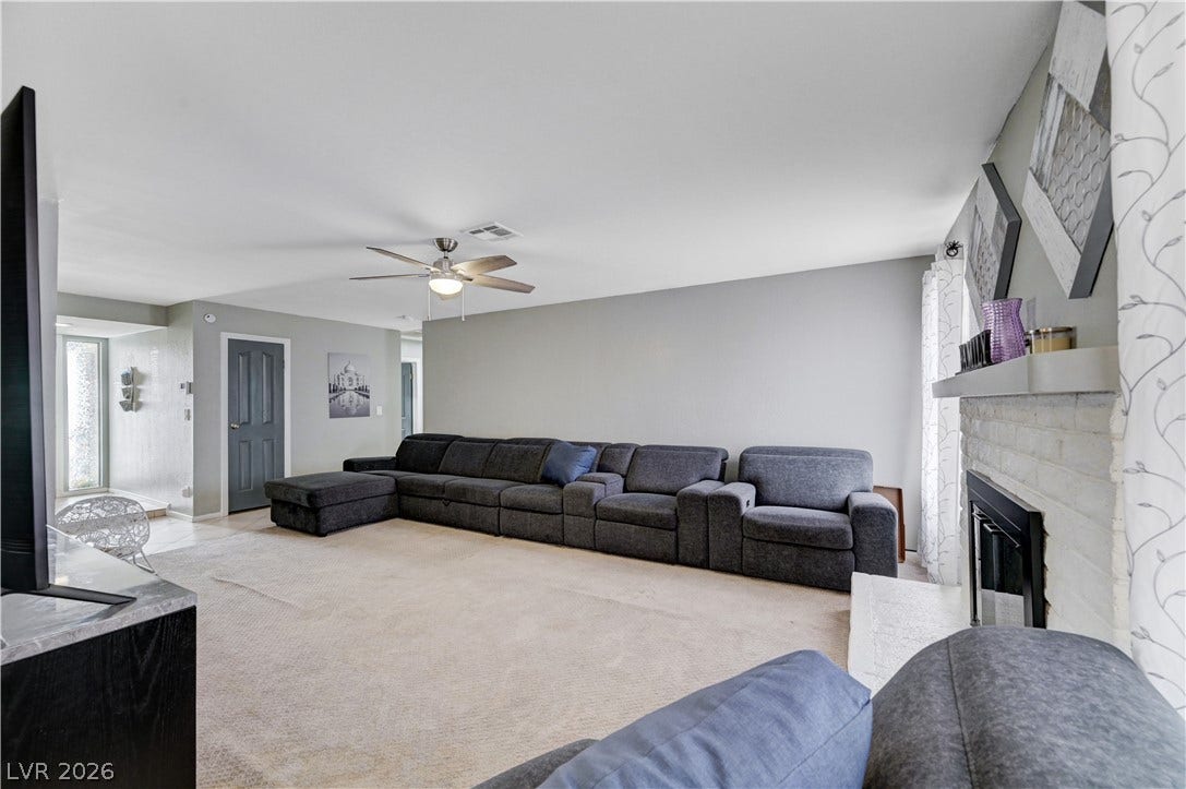 2829 N Michael Way, Las Vegas, NV 89108 An inviting fireplace anchor this comfortable living room finished with soft neutral tones.