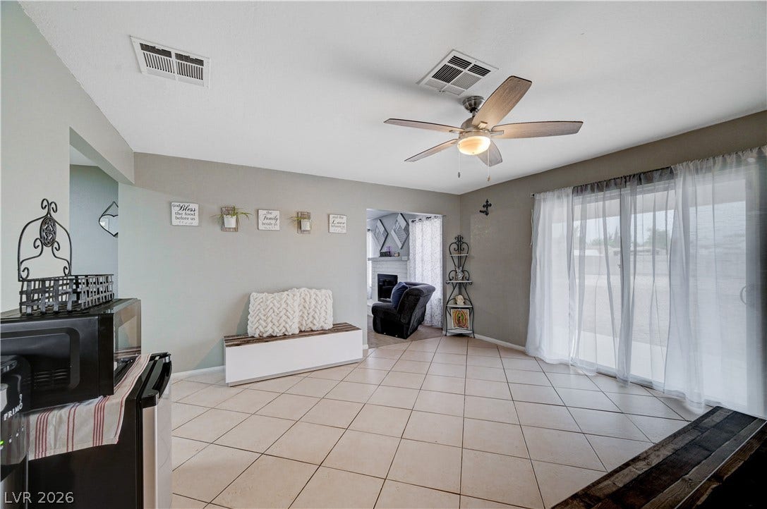 2829 N Michael Way, Las Vegas, NV 89108 Sliding glass doors open from a tile-floored living area to the outdoors.