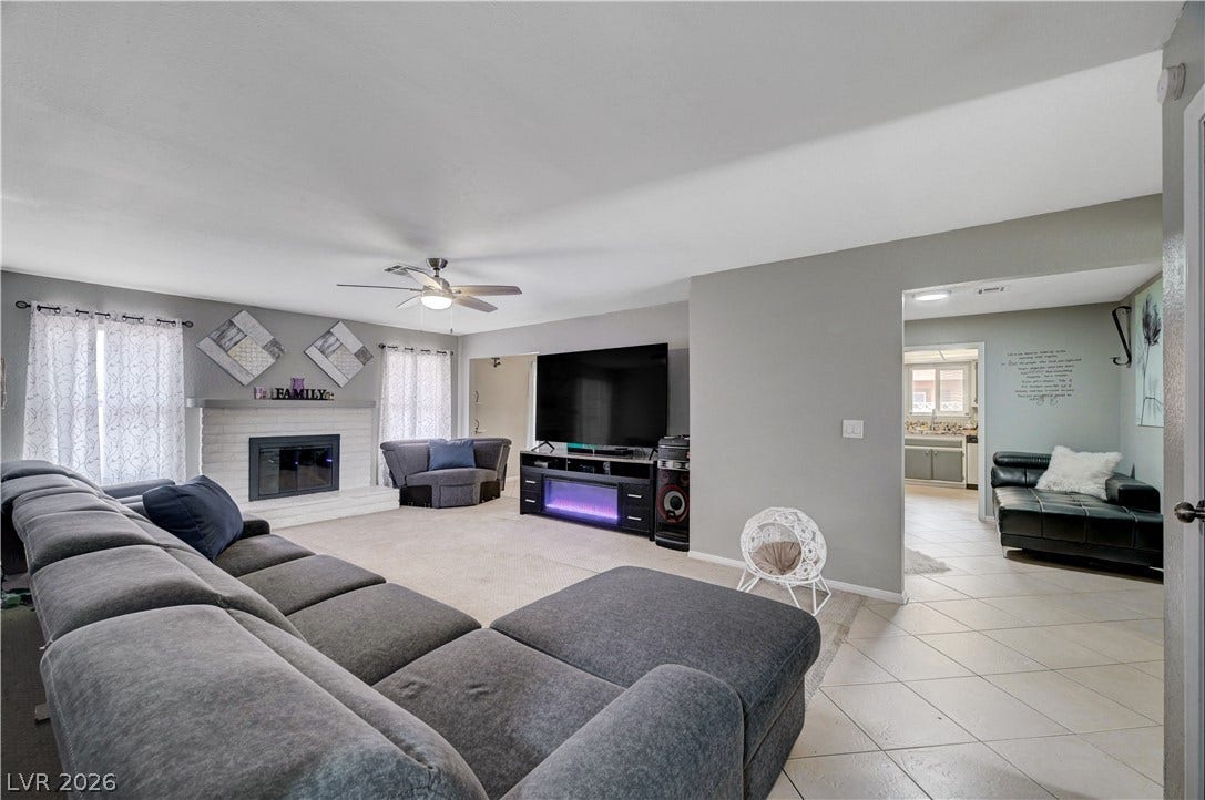2829 N Michael Way, Las Vegas, NV 89108 An open layout connects the carpeted living space to tiled entryways.