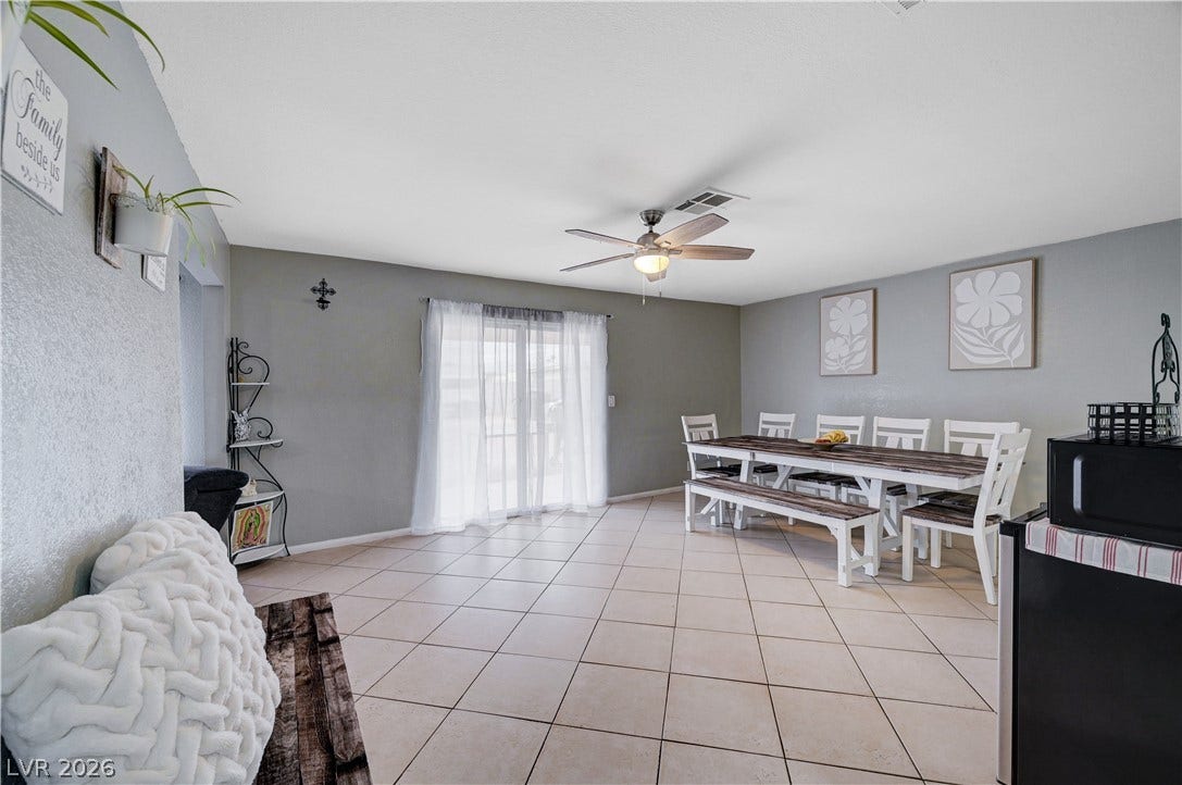 2829 N Michael Way, Las Vegas, NV 89108 Tiled flooring and a sliding glass door define this spacious dining area.