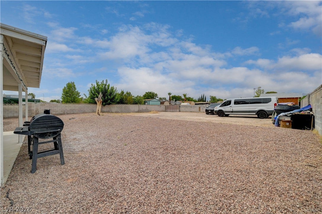 2829 N Michael Way, Las Vegas, NV 89108 An expansive gravel yard offers plenty of open space under a wide blue sky.