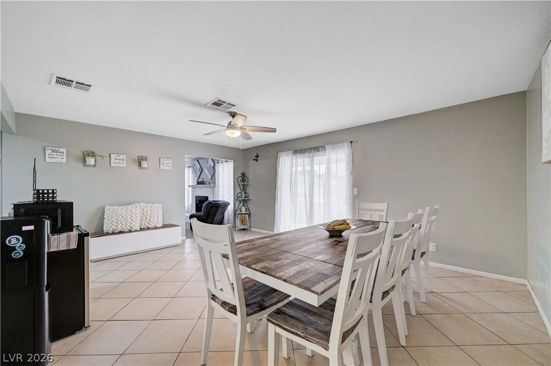 2829 N Michael Way, Las Vegas, NV 89108 Sliding glass doors open from the dining space with tiled flooring and an open layout.