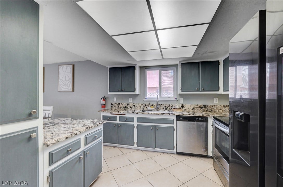 2829 N Michael Way, Las Vegas, NV 89108 Gleaming stone countertops and classic tile flooring define this highly functional workspace.