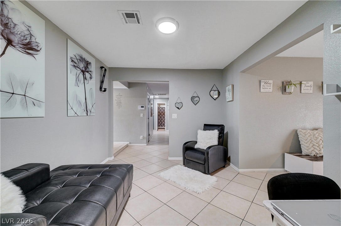 2829 N Michael Way, Las Vegas, NV 89108 Tiled flooring and neutral walls define this versatile transition area leading to other living spaces.