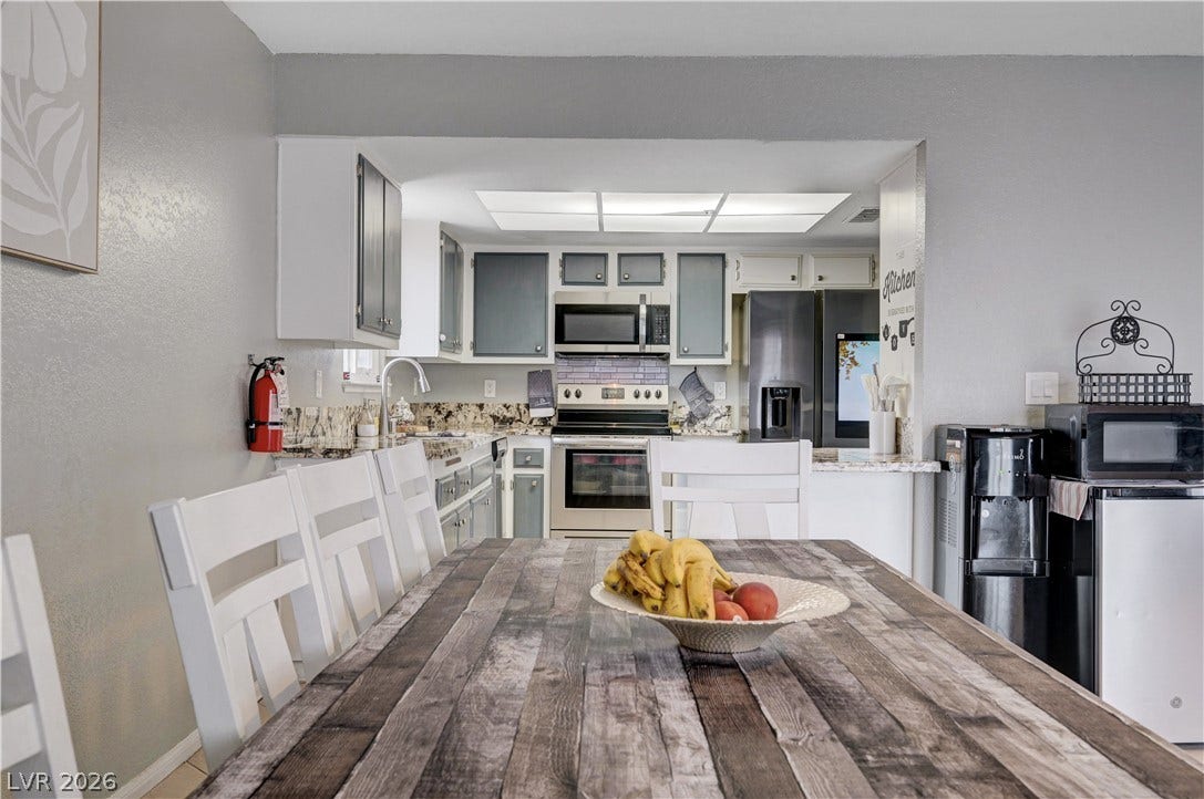 2829 N Michael Way, Las Vegas, NV 89108 An open layout connects the dining space directly to a fully equipped modern kitchen.