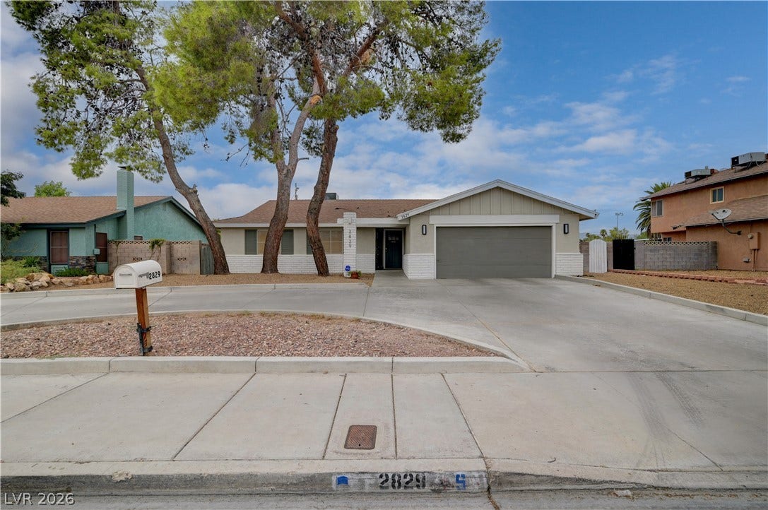 2829 N Michael Way, Las Vegas, NV 89108 Mature trees shade the front yard of this single-story home with an attached garage.