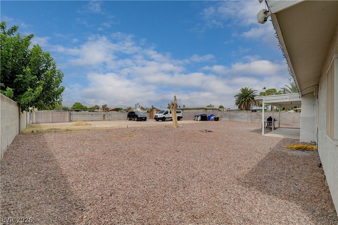 2829 N Michael Way, Las Vegas, NV 89108 An expansive low-maintenance gravel yard offers endless potential and a covered patio area.