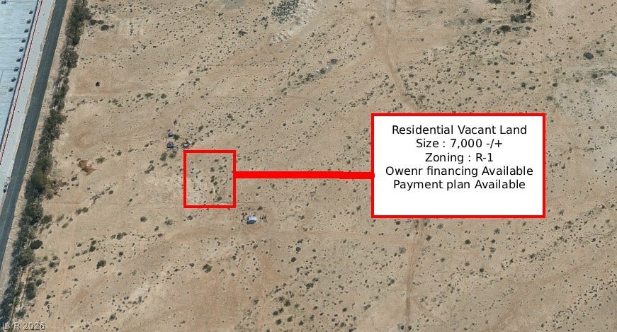 Tamrin, North Las Vegas, NV 89030 An aerial perspective showcases a vacant desert parcel positioned near a paved roadway.