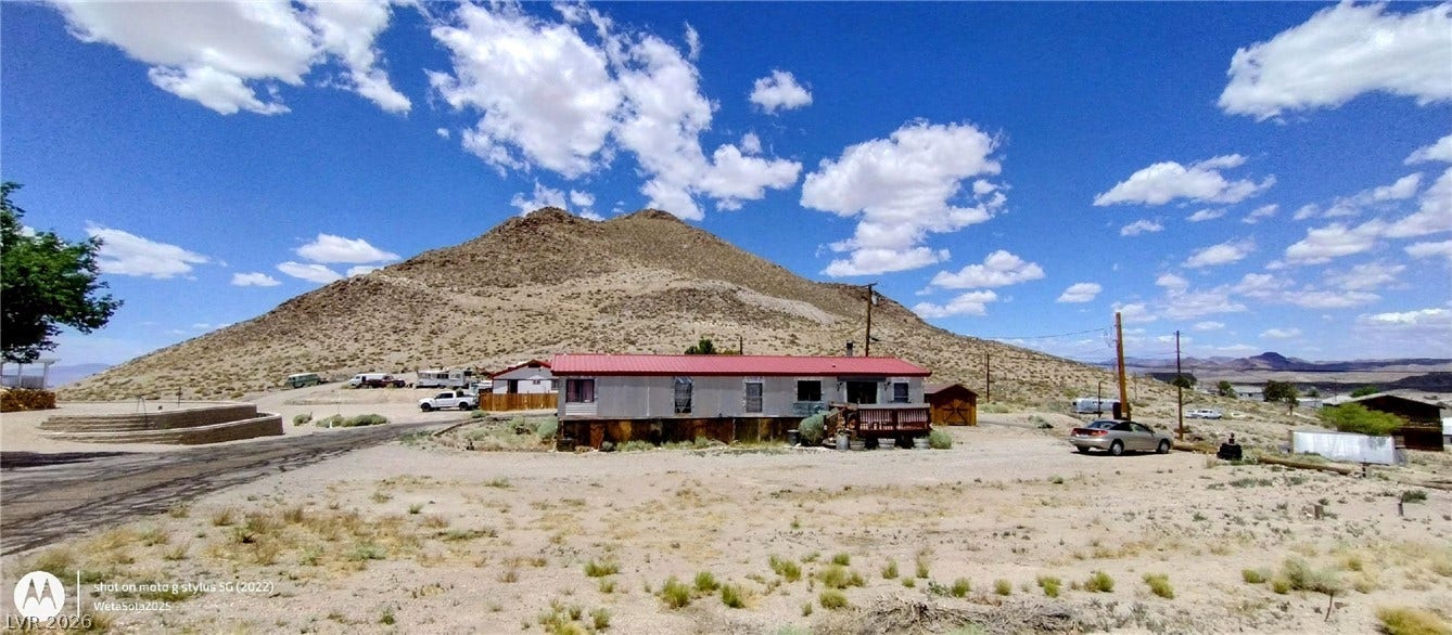 Dramatic mountain vistas frame this desert property set against a bright blue sky.