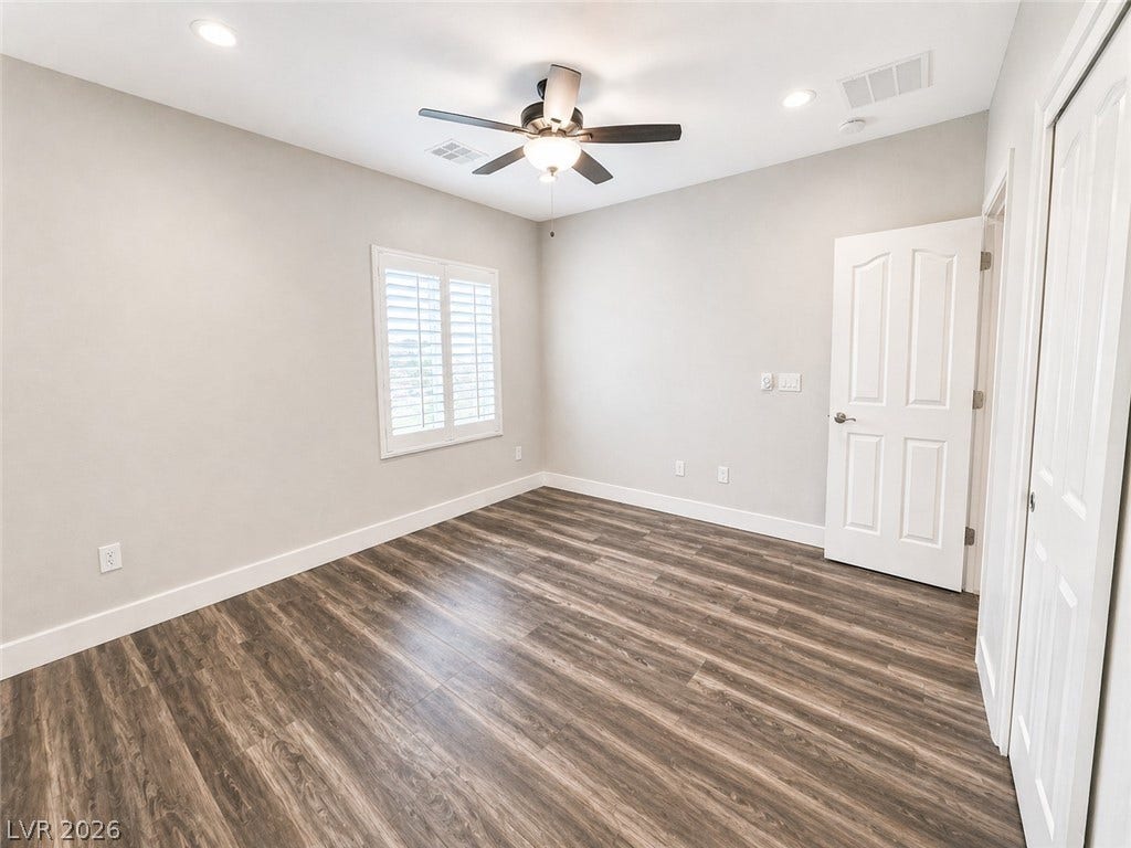 2237 Merrimack Valley Avenue, Henderson, NV 89044 classic plantation shutters define this versatile secondary bedroom.