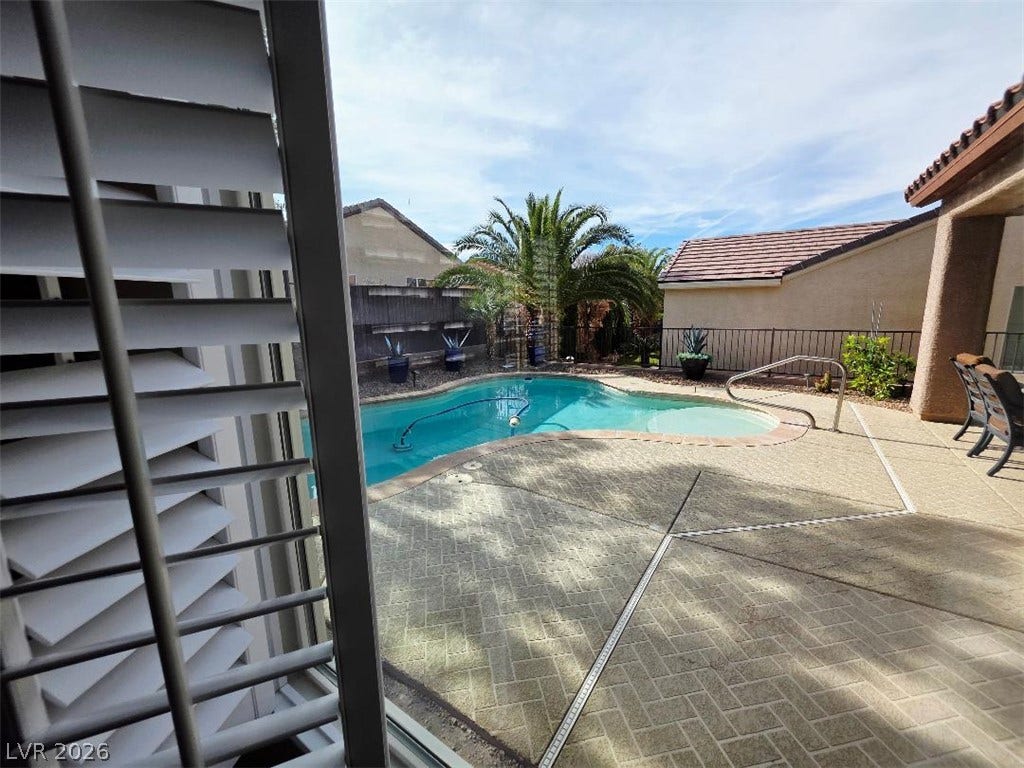 2237 Merrimack Valley Avenue, Henderson, NV 89044 An inviting backyard oasis features a shimmering swimming pool framed by textured hardscaping.