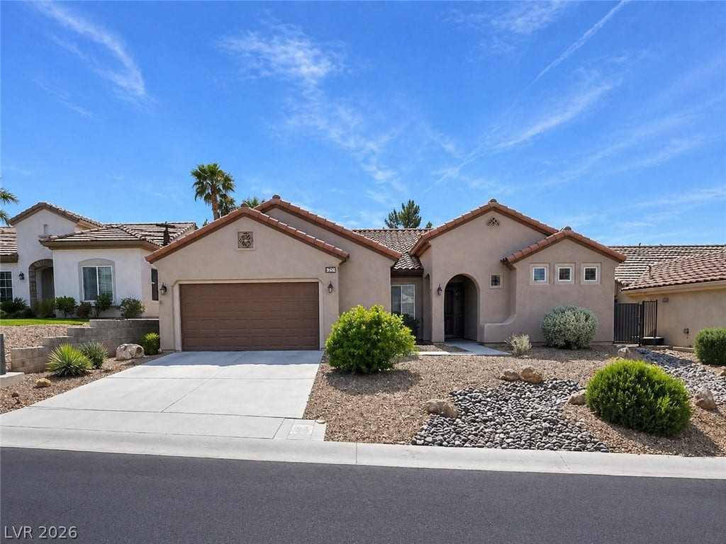 2237 Merrimack Valley Avenue, Henderson, NV 89044 Spanish tile roofing and low-maintenance desert landscaping define this inviting single-story facade.