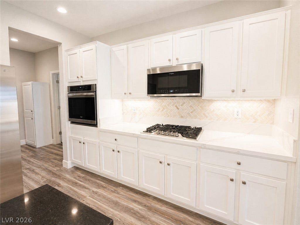 2237 Merrimack Valley Avenue, Henderson, NV 89044 Gleaming stone countertops and classic cabinetry elevate this modern culinary space lots of storage space