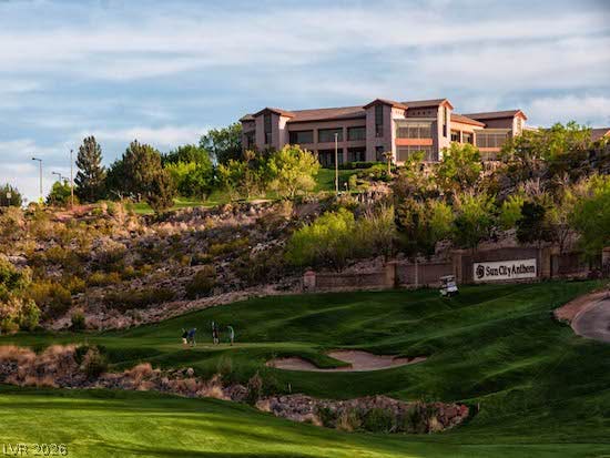 2237 Merrimack Valley Avenue, Henderson, NV 89044 A grand multi-level clubhouse overlooks a rolling golf course green under a soft sky.