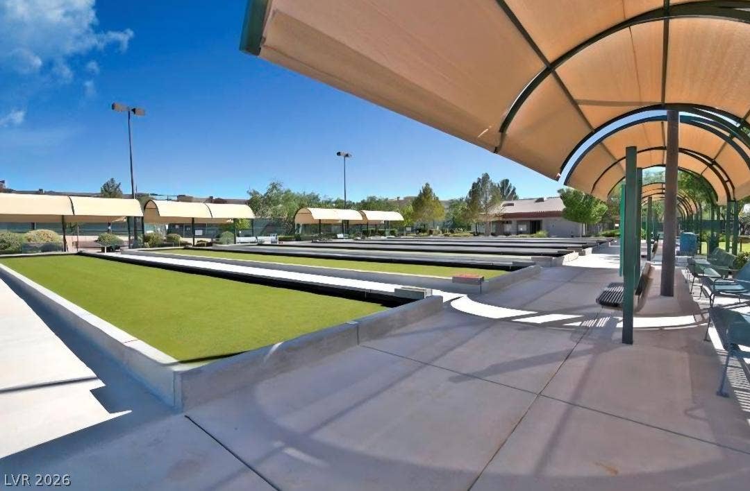 2237 Merrimack Valley Avenue, Henderson, NV 89044 Shaded viewing areas overlook manicured outdoor recreation courts under a clear blue sky.