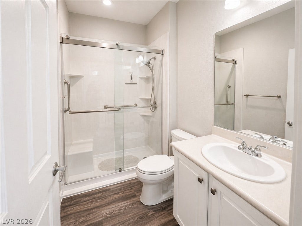 2237 Merrimack Valley Avenue, Henderson, NV 89044 A classic vanity and glass-door shower create a functional layout on modern tile floors