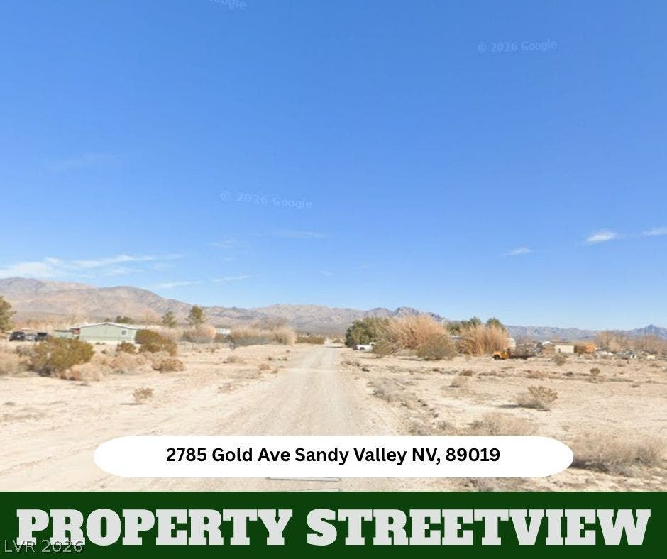 Dramatic mountain vistas frame this desert landscape under wide open blue skies.