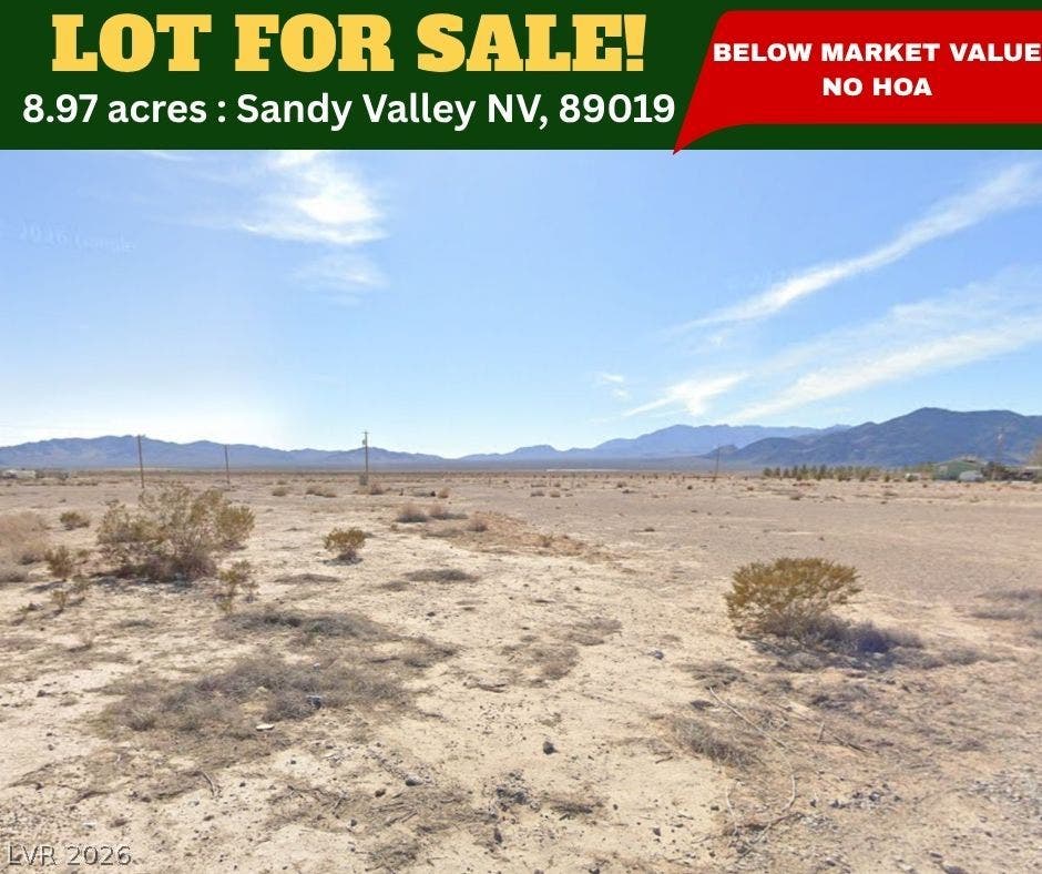 Panoramic mountain backdrops frame this vast desert acreage under clear open skies.