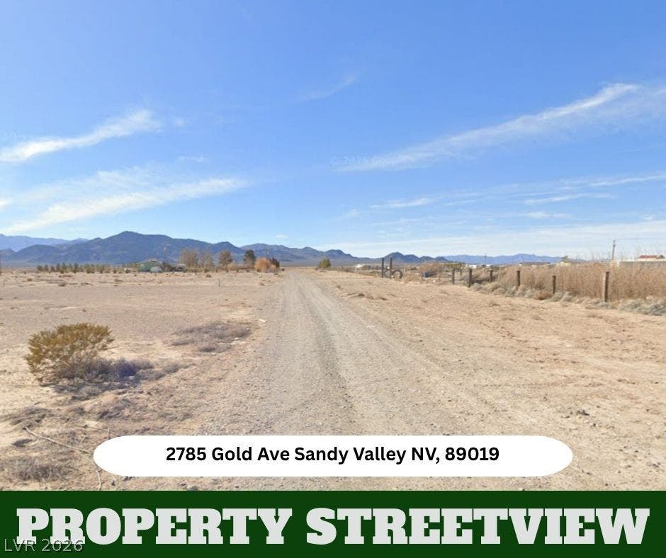 Dramatic mountain backdrops frame this open desert acreage under vast blue skies.