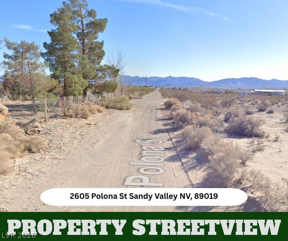 Distant mountains frame the wide desert horizon along a quiet unpaved country road.
