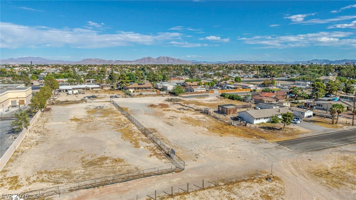 Distant mountains frame this level parcel of land set within an established neighborhood.