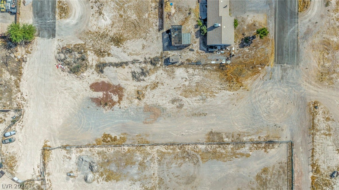 An aerial perspective showcases the spacious lot boundaries and surrounding desert terrain.