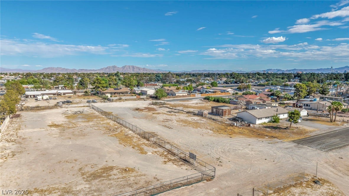 A spacious level lot provides sweeping mountain views under vast blue skies.