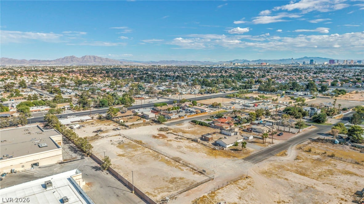 Distant mountain ranges and city skyline views frame this expansive parcel of land.