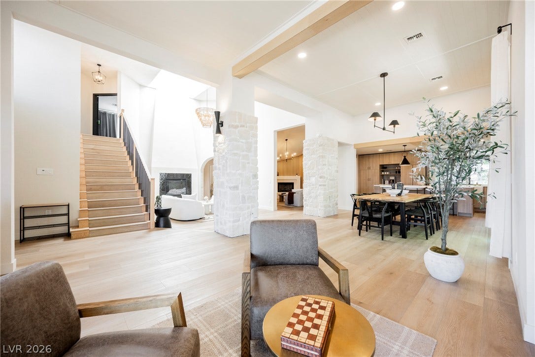 5741 S Pearl Street, Las Vegas, NV 89120 A spacious open-concept interior layout integrates living and dining areas separated by structural stone pillars.