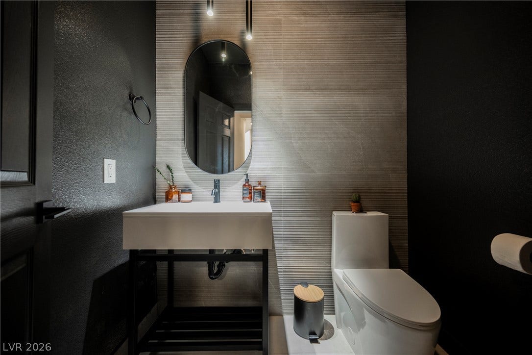 5741 S Pearl Street, Las Vegas, NV 89120 A contemporary textured feature wall enhances this modern powder room.