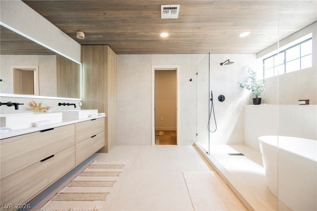 5741 S Pearl Street, Las Vegas, NV 89120 Sleek tile floors and a wood-plank ceiling define this contemporary primary bath retreat.