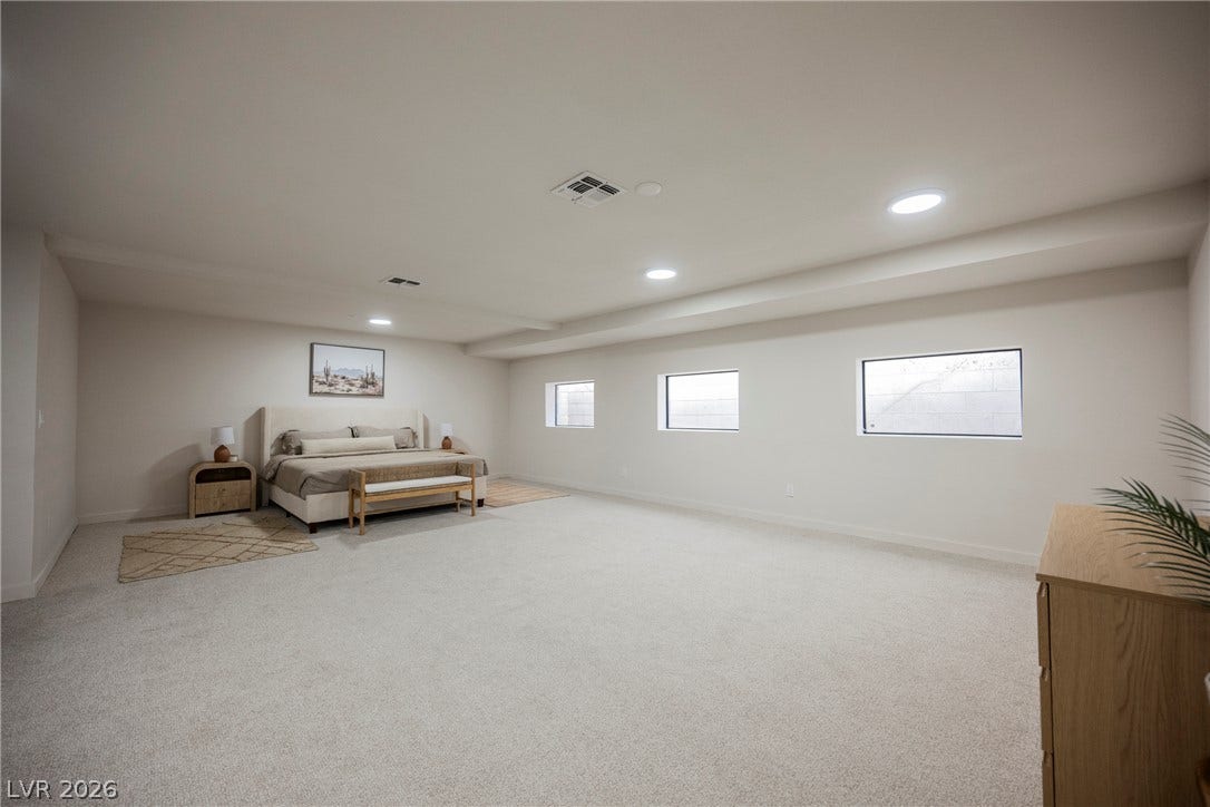 5741 S Pearl Street, Las Vegas, NV 89120 A spacious lower level bedroom features plush carpeting, recessed lighting, and high ceilings.