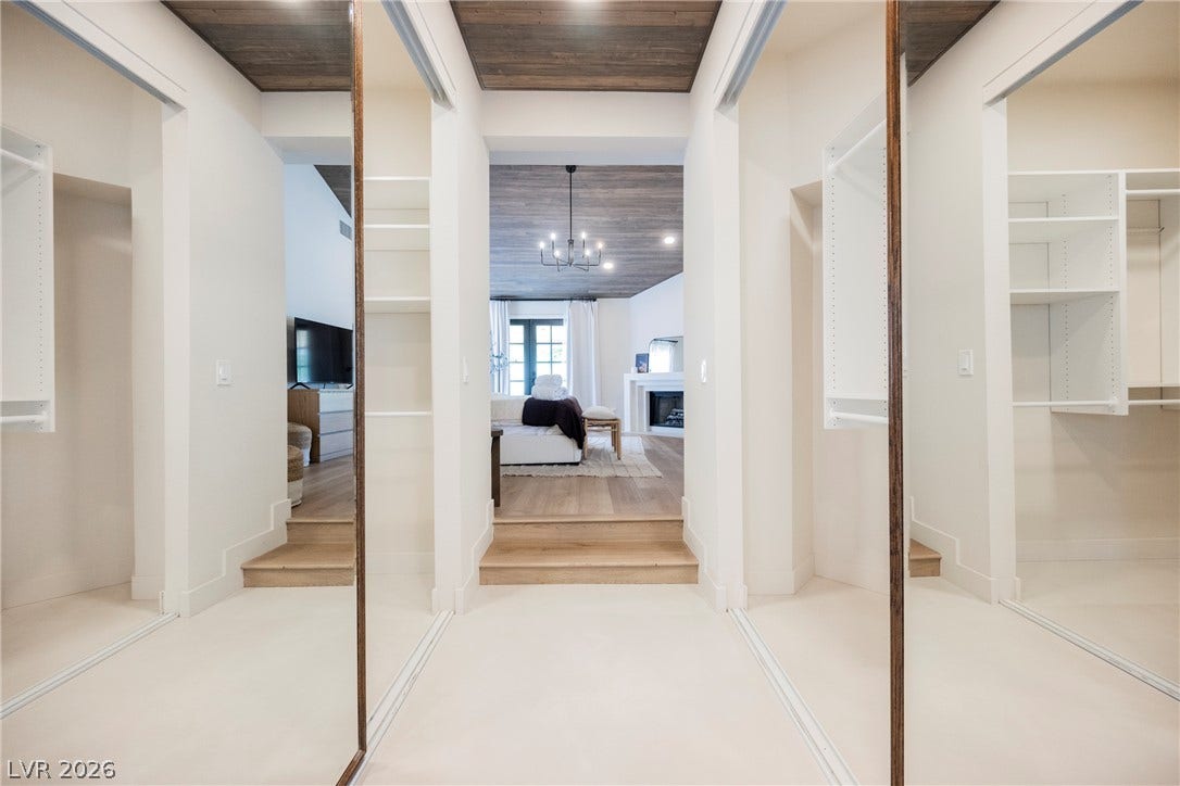 5741 S Pearl Street, Las Vegas, NV 89120 Wood ceilings and custom built-in shelving elevate this well-designed walk-in closet space.