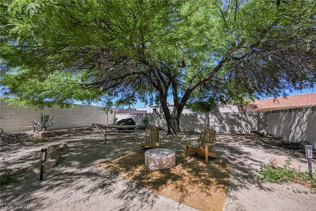 5741 S Pearl Street, Las Vegas, NV 89120 Mature trees shade a private backyard enclosed by solid block walls.