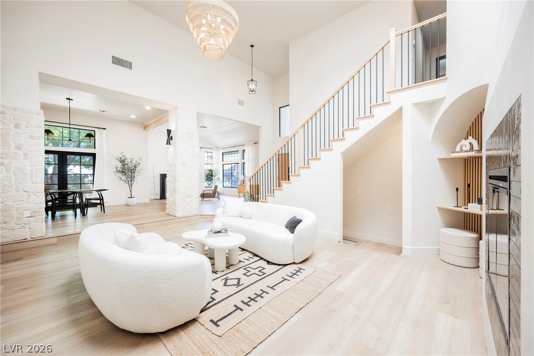 5741 S Pearl Street, Las Vegas, NV 89120 Sunlight streams across the light wood floors of this airy double-height living area.