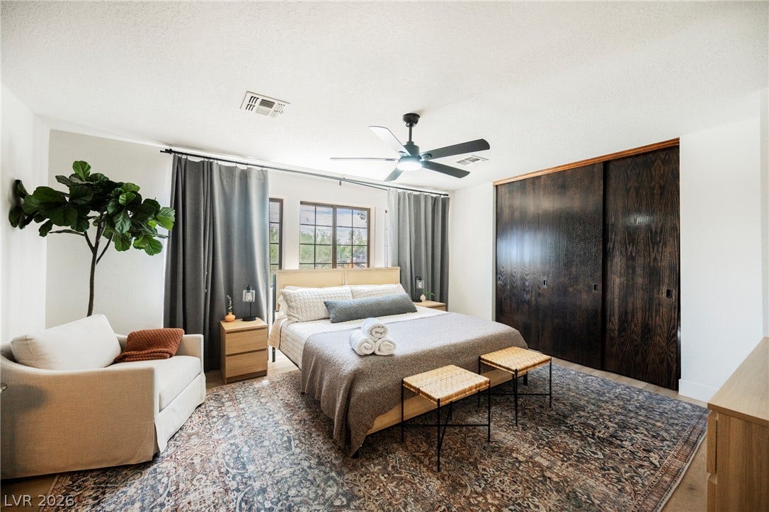 5741 S Pearl Street, Las Vegas, NV 89120 Rich wood-toned sliding doors and wide windows bring natural warmth to this peaceful bedroom.